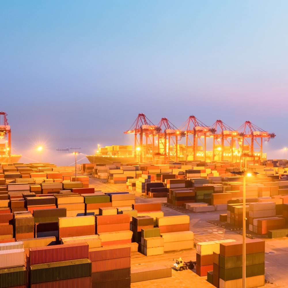 container wharf in nightfall, international import and export trade background